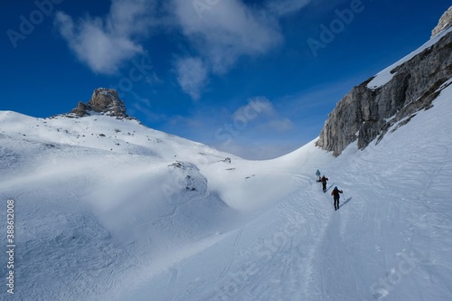 Group of skiers during ski touring in beautiful winter mountain scenery. Tre Cime Park, Dolomites, Italy