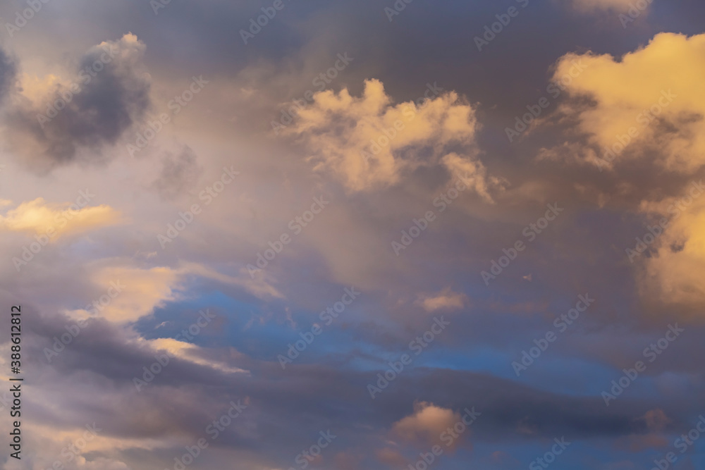 evening blue sky with clouds beautifully illuminated by the sun as a natural background