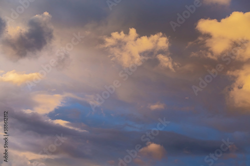 evening blue sky with clouds beautifully illuminated by the sun as a natural background