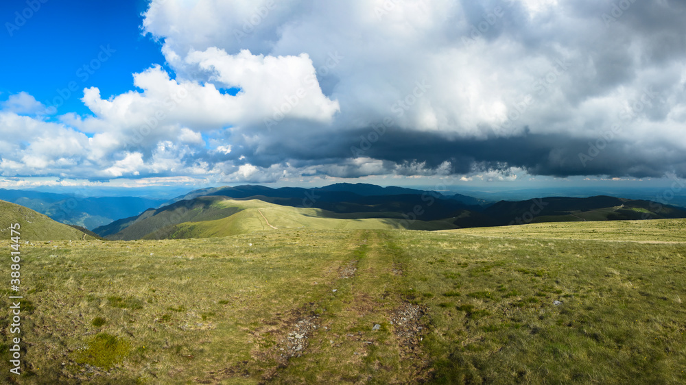 Stormy clouds over high altitude grasslands of Capatanii Mountains, Carpathians, Romania. Spring Season