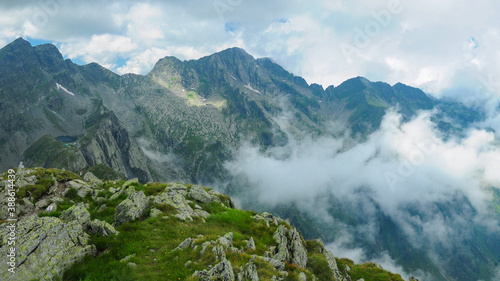 Clouds and fog over Fagaras Mountains peaks. On left side Caltun glacial lake can be seen.