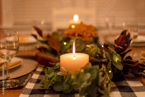 Quadro su tela Cozy dinner table setting by candlelight