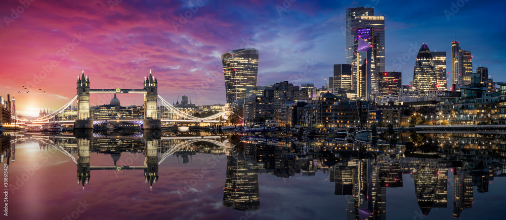 The lit urban skyline with City of London and Tower Bridge just after sunset time with reflections in the river Thames, United Kingdom - obrazy, fototapety, plakaty 