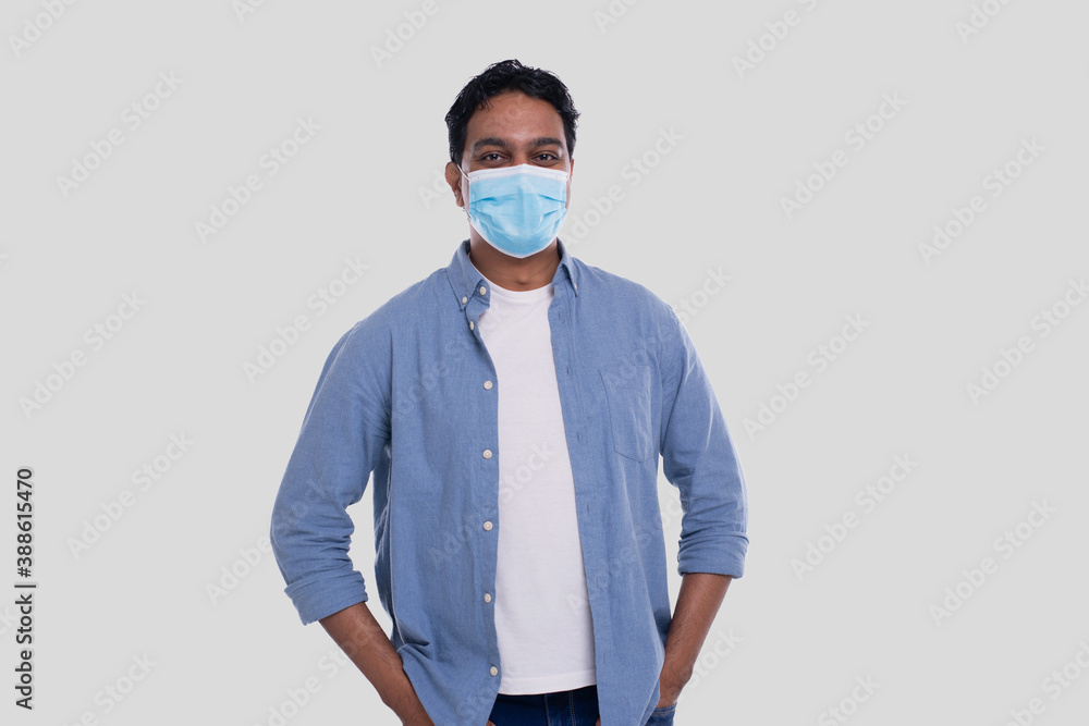 Indian Man Wearing Medical Mask Isolated. Man In Blue Shirt with Medical Mask. Health, Virus, Medical Concept Indian Man Wearing Medical Mask Isolated. Man In Blue Shirt with Medical Mask. Health, Virus, Medical Concept