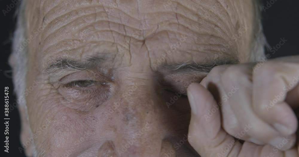 Old man is crying. Loneliness concept. Elderly, aged guy is in sad, depression. Macro shot of retired senior man's eye. Old man is crying. Loneliness concept. Elderly, aged guy is in sad, depression. Macro shot of retired senior man's eye.