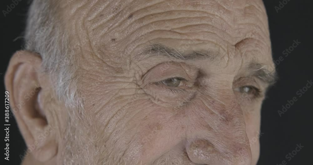 Old senior man's close up, macro shot of smiling eyes. Happy retired grandparent close up eyeball. Old senior man's close up, macro shot of smiling eyes. Happy retired grandparent close up eyeball.