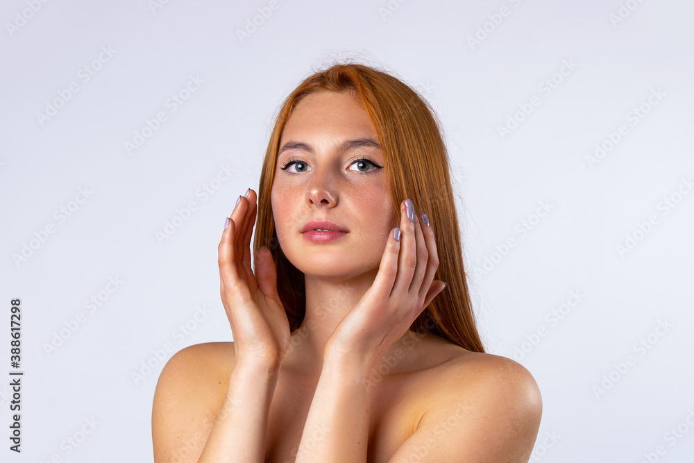 Beautiful young woman with clean fresh skin touching her own face. Facial treatment. Cosmetology, beauty and spa. Photo on white background Beautiful young woman with clean fresh skin touching her own face. Facial treatment. Cosmetology, beauty and spa. Photo on white background