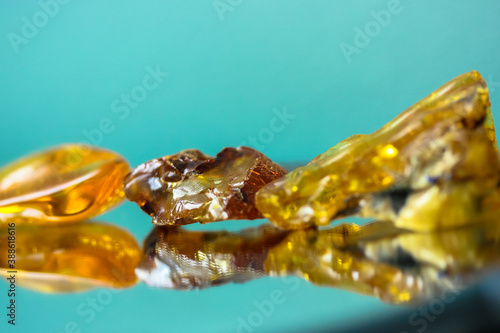 Wallpaper Mural A piece of natural amber on a mirror surface, a reflection of a yellow semi-precious stone Torontodigital.ca