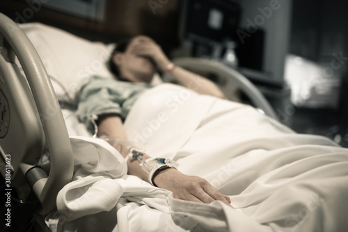 Sick woman lying in hospital bed 