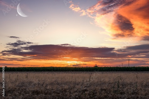 Ramadan background with a crescent and sunset sky. beautiful dawn in the morning in the field