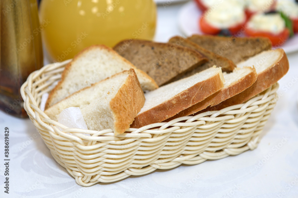 Bread slices in a basket. Appetizer on the dining table. Bread slices in a basket. Appetizer on the dining table.