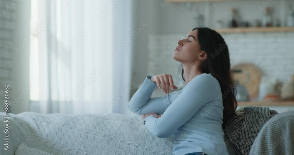 Autumn depression. Young sad woman sitting alone at home, looking aside, suffering from bad mood Autumn depression. Young sad woman sitting alone at home, looking aside, suffering from bad mood