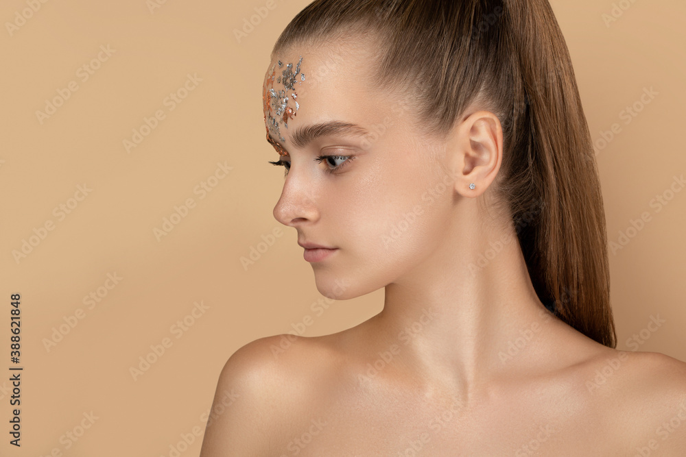 beautiful girl in profile on a beige background. beauty portrait close-up. beautiful girl in profile on a beige background. beauty portrait close-up.