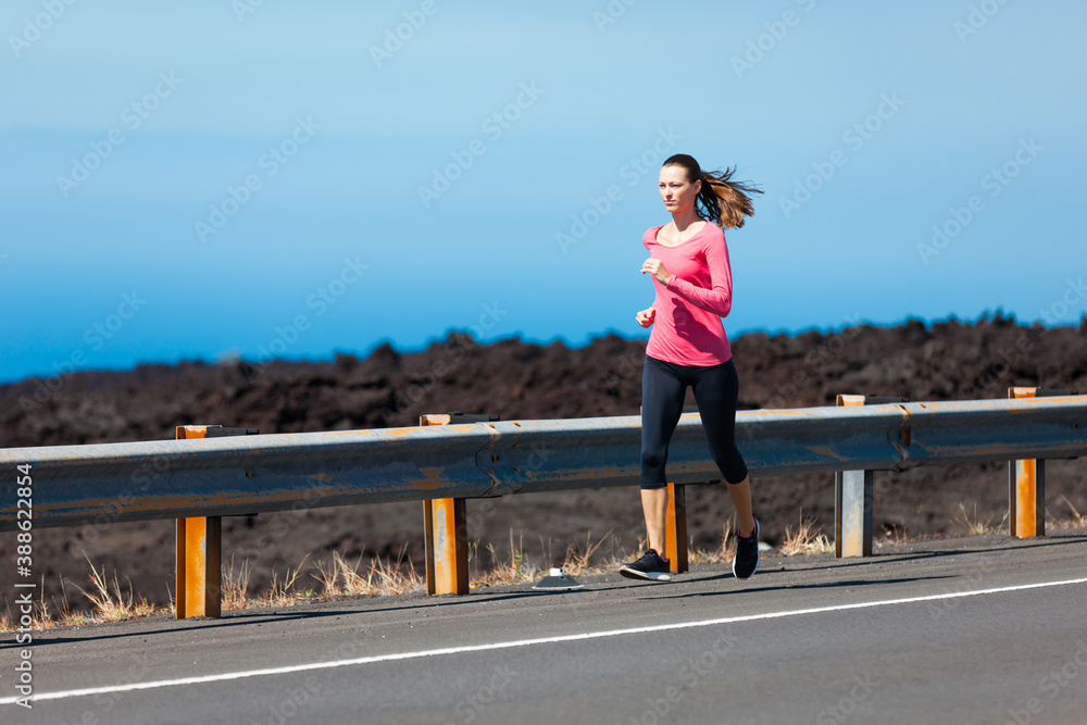 Woman running down road 