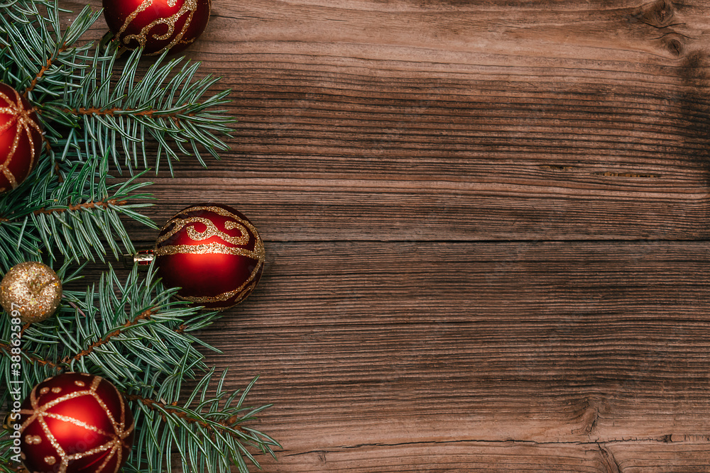 Frame made of Christmas tree branches with red and gold balls on a dark wooden background.New Year,Christmas concept. Copy space for text,top view, selective focus with shallow depth of field Frame made of Christmas tree branches with red and gold balls on a dark wooden background.New Year,Christmas concept. Copy space for text,top view, selective focus with shallow depth of field