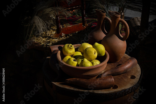 still life with quince near two jugs on an authentic table 