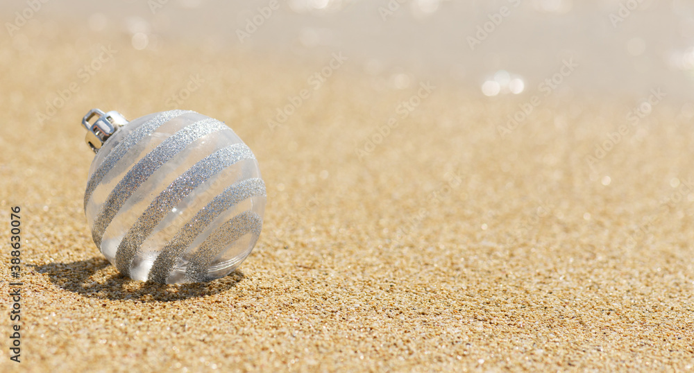 Christmas white glitter ball on the tropical beach near ocean, a summer Christmas and winter holyday concept. Merry Christmas and Happy New Year background, Christmas white glitter ball on the tropical beach near ocean, a summer Christmas and winter holyday concept. Merry Christmas and Happy New Year background,