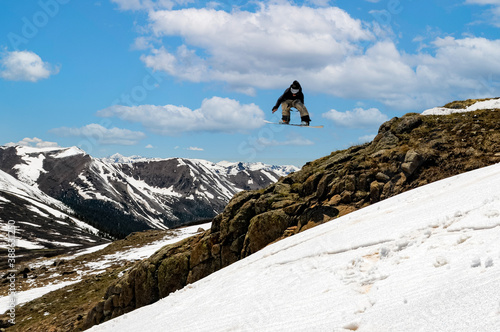 snowboarder jumping in back county late season © hayden