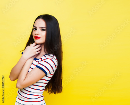 lifestyle people concept: pretty young school teenage girl having fun happy smiling on yellow background © iordani