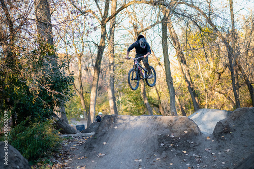 Photography Young boy jumping on the bicycle