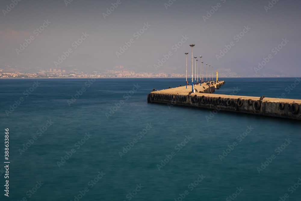 Alanya, Turkey - august 2020: Alanya Bay pier and promenade. Resort town in Turkey. Long exposure picture
