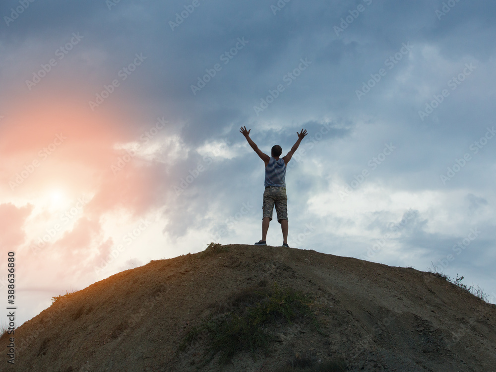 Man on the Top of the Mountain Raised His Hands Looking Up at the Beautiful Dawn Man on the Top of the Mountain Raised His Hands Looking Up at the Beautiful Dawn
