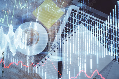 Double exposure of forex chart drawing over table background with computer. Concept of financial research and analysis. Top view.