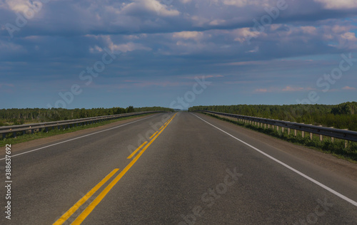 highway under blue sky with clouds