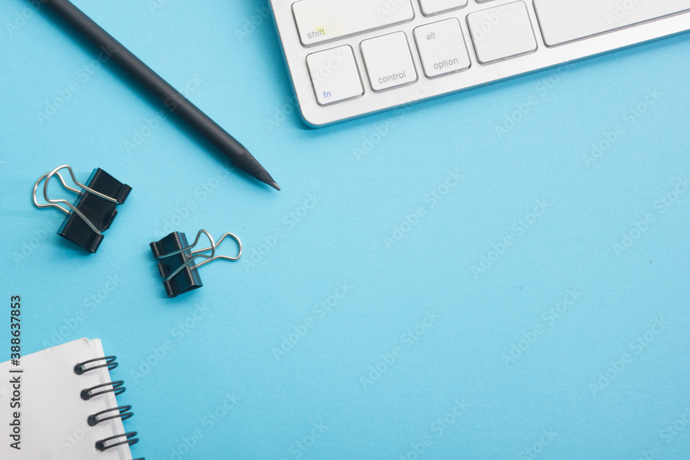 Blue desk office with laptop, smartphone and other work supplies with cup of coffee. Top view with copy space for input the text. Designer workspace on desk table essential elements on flat lay Blue desk office with laptop, smartphone and other work supplies with cup of coffee. Top view with copy space for input the text. Designer workspace on desk table essential elements on flat lay