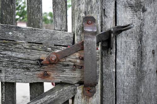 Village theme. Photo of a gate with a handmade latch