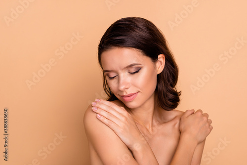 Close up photo beautiful she her lady eyes closed hands arms touch herself shoulder skin healthy natural soft shiny ideal condition breast cancer protection wear no clothes isolated beige background