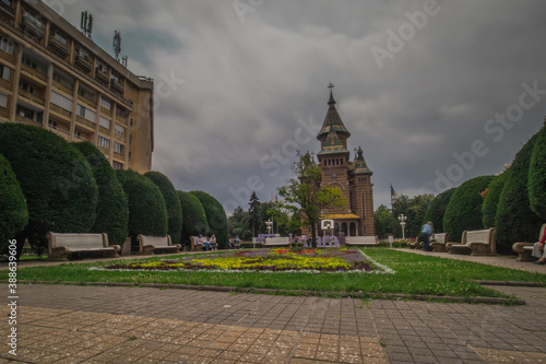 Orthodox cathedral in Timisoara, viewed from a park or a city square on a dull cloudy day.