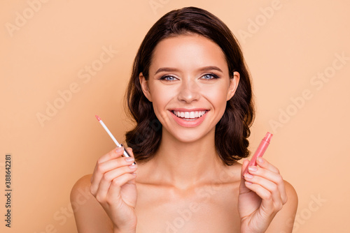 Close up photo beautiful amazing she her lady hold new collection pomade great result lipgloss go date choice choose color mirror shower bath wear nothing isolated beige pastel background photo