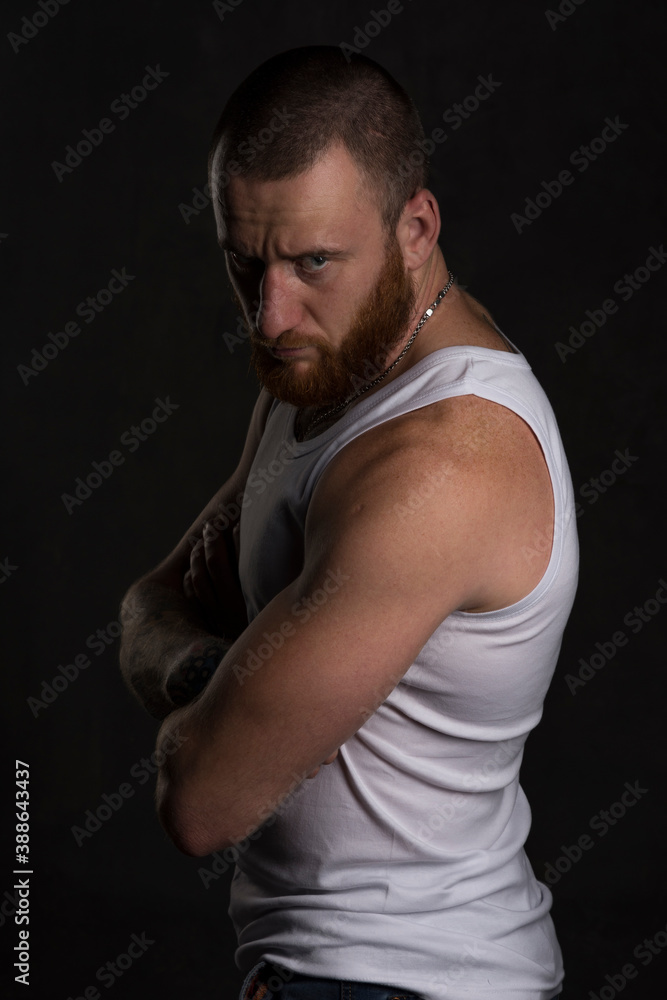 Serious man in undershirt in studio session Serious man in undershirt in studio session