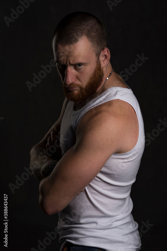 Serious man in undershirt in studio session