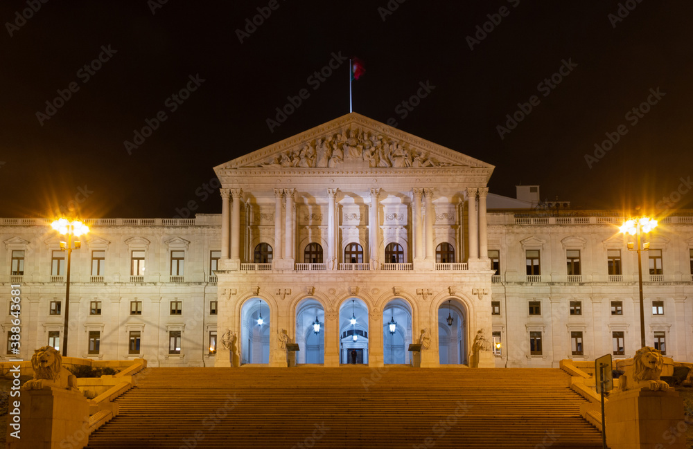 Naklejka premium Lisbon Parliament building illuminated at night. Neoclassical architectural style iconic landmark in the capital of Portugal