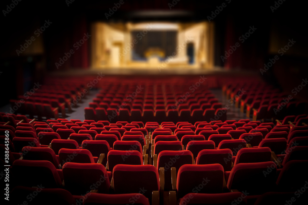 Empty red armchairs of a theater ready for a show - obrazy, fototapety, plakaty 