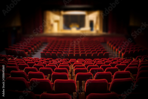 Empty red armchairs of a theater ready for a show photo