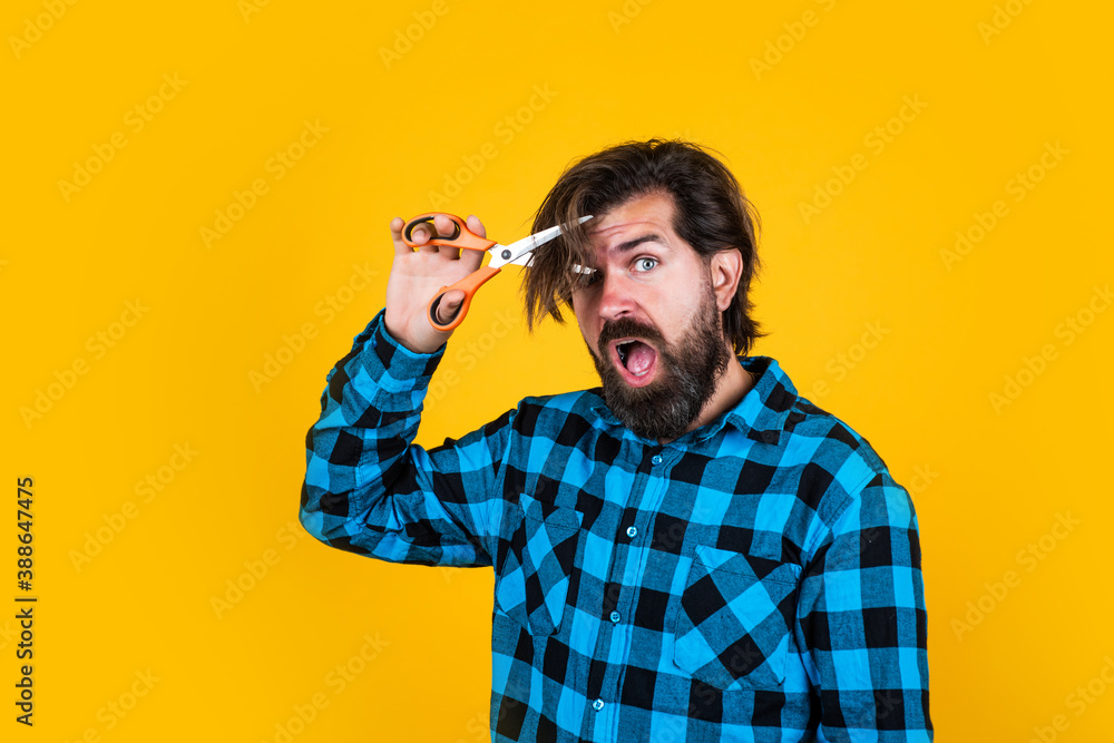 amazed brutal male hipster cut his brunette hair with scissors, barber master amazed brutal male hipster cut his brunette hair with scissors, barber master