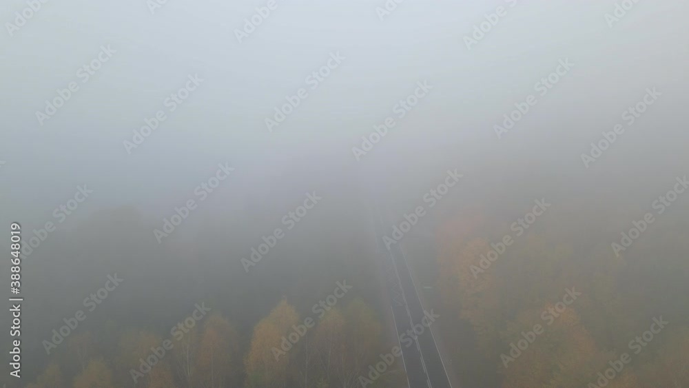 Fog And Clouds Over Mountain Road In Forest At Early Morning In Napromek, Poland. - aerial drone shot Fog And Clouds Over Mountain Road In Forest At Early Morning In Napromek, Poland. - aerial drone shot
