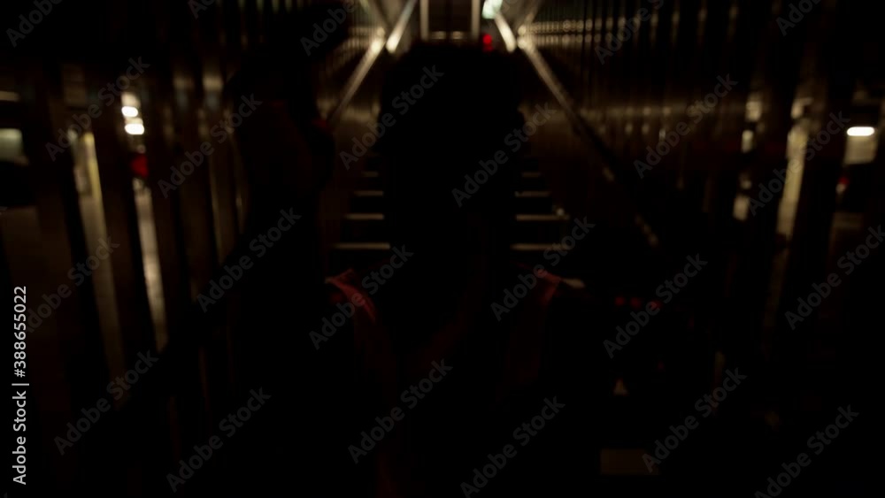 Young Black Guy Dancing On The Stairs. He Moves Rhythmically. Evening. Guy Dancing Modern Dances. Light Changes From Blue To Red. Young Black Guy Dancing On The Stairs. He Moves Rhythmically. Evening. Guy Dancing Modern Dances. Light Changes From Blue To Red.
