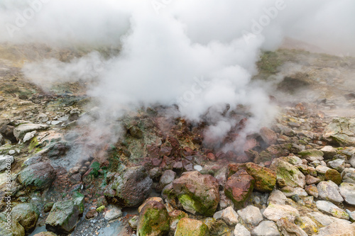 Picturesque view of volcanic landscape, aggressive hot spring, eruption fumarole, gas-steam activity in crater active volcano. Amazing mount landscape, travel destinations for active vacation, hiking.