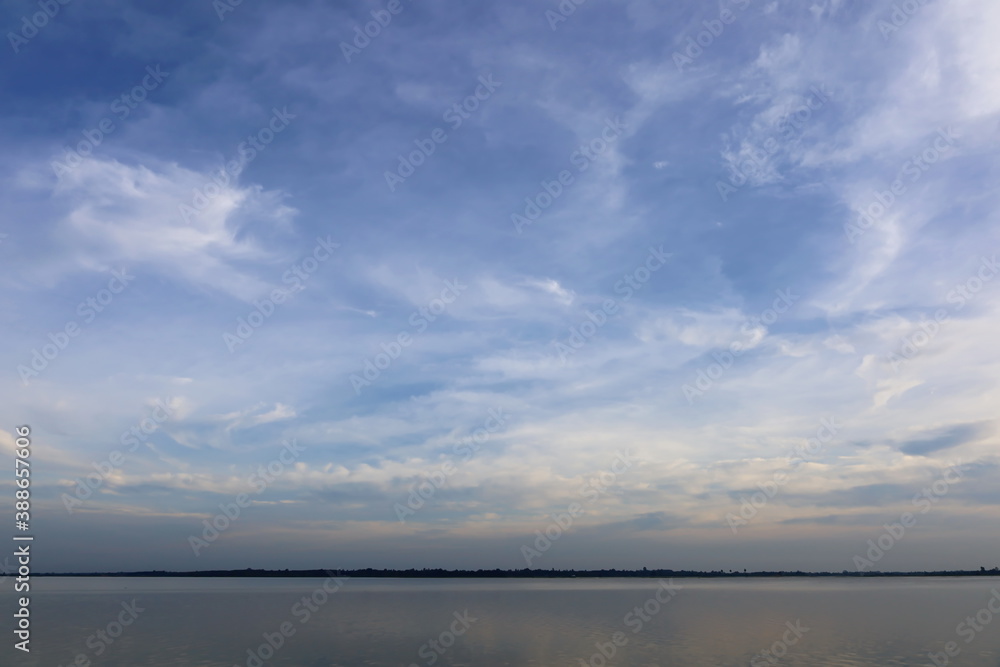 Sky landscape above the reservoir. The dim atmosphere of the sky and the twilight background for the design. Selective focus Sky landscape above the reservoir. The dim atmosphere of the sky and the twilight background for the design. Selective focus