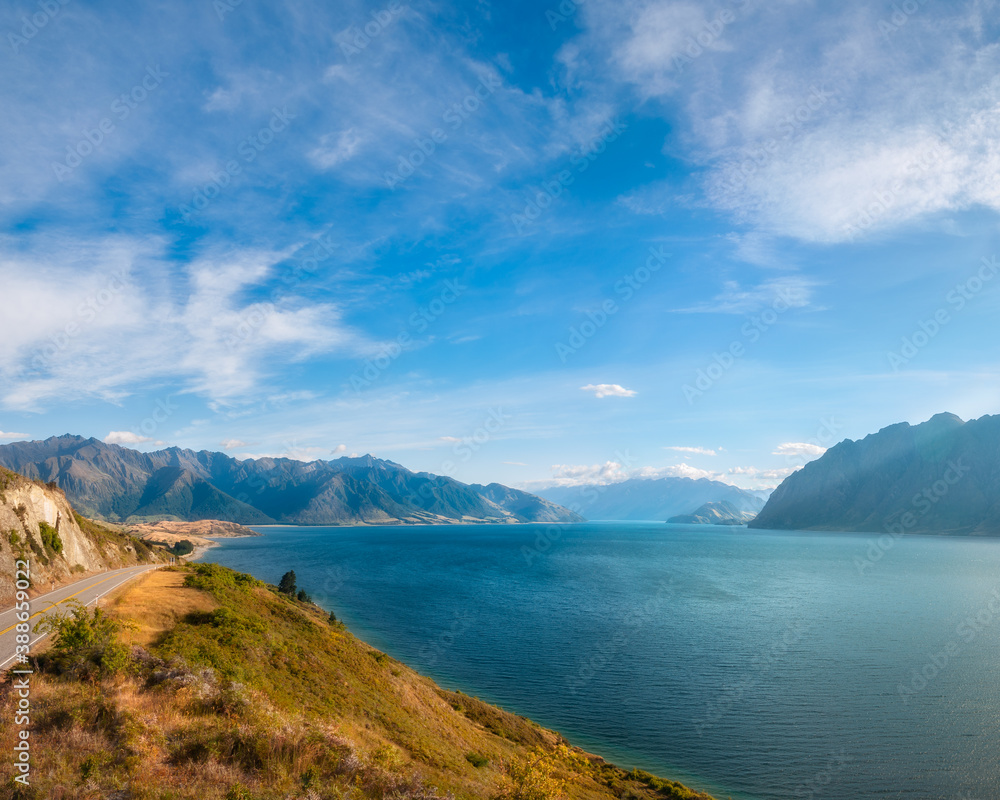 Lake Hawea Vertical Panorama in beautiful morning light with mountain peaks in the distance in Otago Region, New Zealand, Southern Alps.