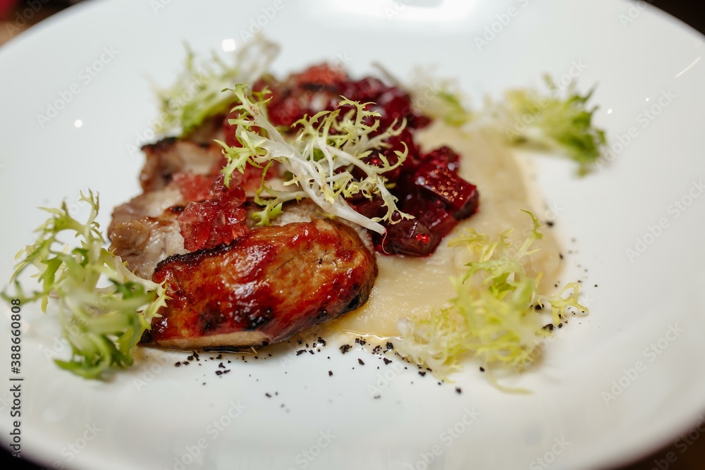 Grilled pork steak with green salad on a wooden table, top view Grilled pork steak with green salad on a wooden table, top view