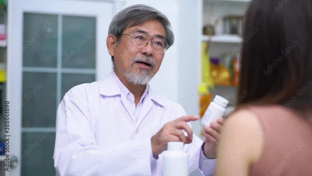 Pharmacist explained to asian female patients drug capsules detail in pharmacy store Thailand footage video 4k Pharmacist explained to asian female patients drug capsules detail in pharmacy store Thailand footage video 4k
