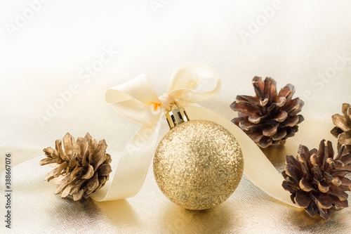 PINE CONES   BEAUTIFUL RIBBON AND NEW YEAR S SHINY BALL.Christmas decorations on white background. SELECTIVE FOCUS