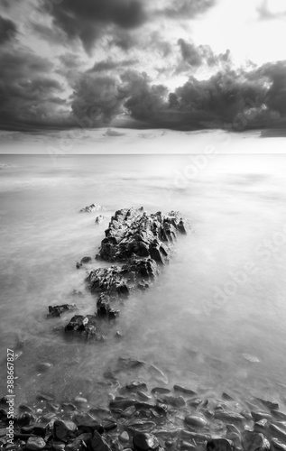 Black-and-white photograph of stones on the sea shore with a long exposure © xotaka