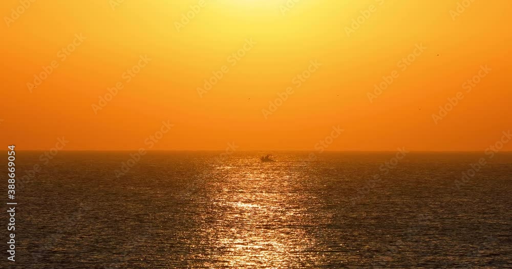 Ocean sunrise 4K video. Sailing boat in sea ripple waves Ocean sunrise 4K video. Sailing boat in sea ripple waves