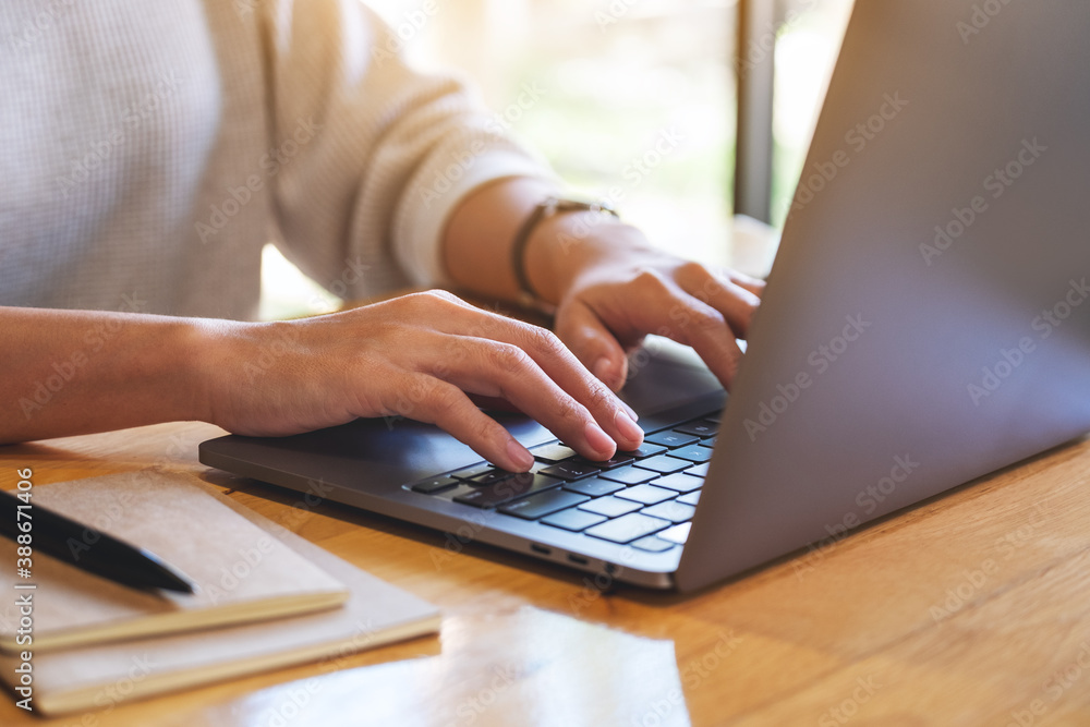 Closeup image of a woman working and typing on laptop computer in office Closeup image of a woman working and typing on laptop computer in office